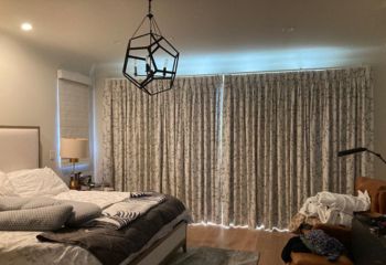 Floral printed custom drapes and sheer curtains installed in a Newport Beach bedroom for privacy and light control.
