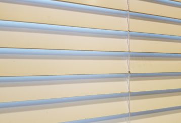 Elegant faux wood blinds complementing a modern living room decor.