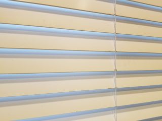 Faux Wood Blinds | Newport Beach Blinds & Shades CA Elegant faux wood blinds complementing a modern living room decor.