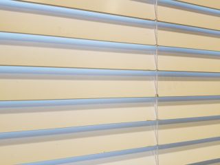 Elegant faux wood blinds complementing a modern living room decor.